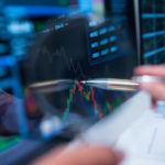 Close-up of pen pointing at the computer screen of the business broker